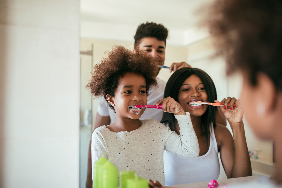 Family brushing teeth together - Houston Dentist